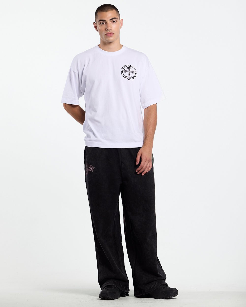 55 SWEATPANTS BLACK - washed black graphic sweatpants, front view on male model - Cold Culture