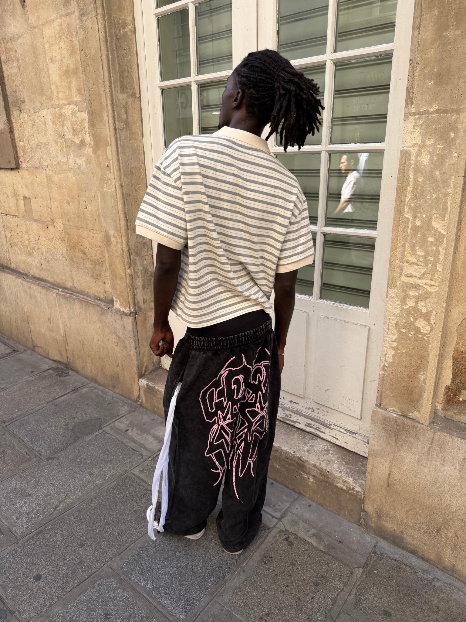 55 SWEATPANTS BLACK - washed black graphic sweatpants, street style shot - Cold Culture