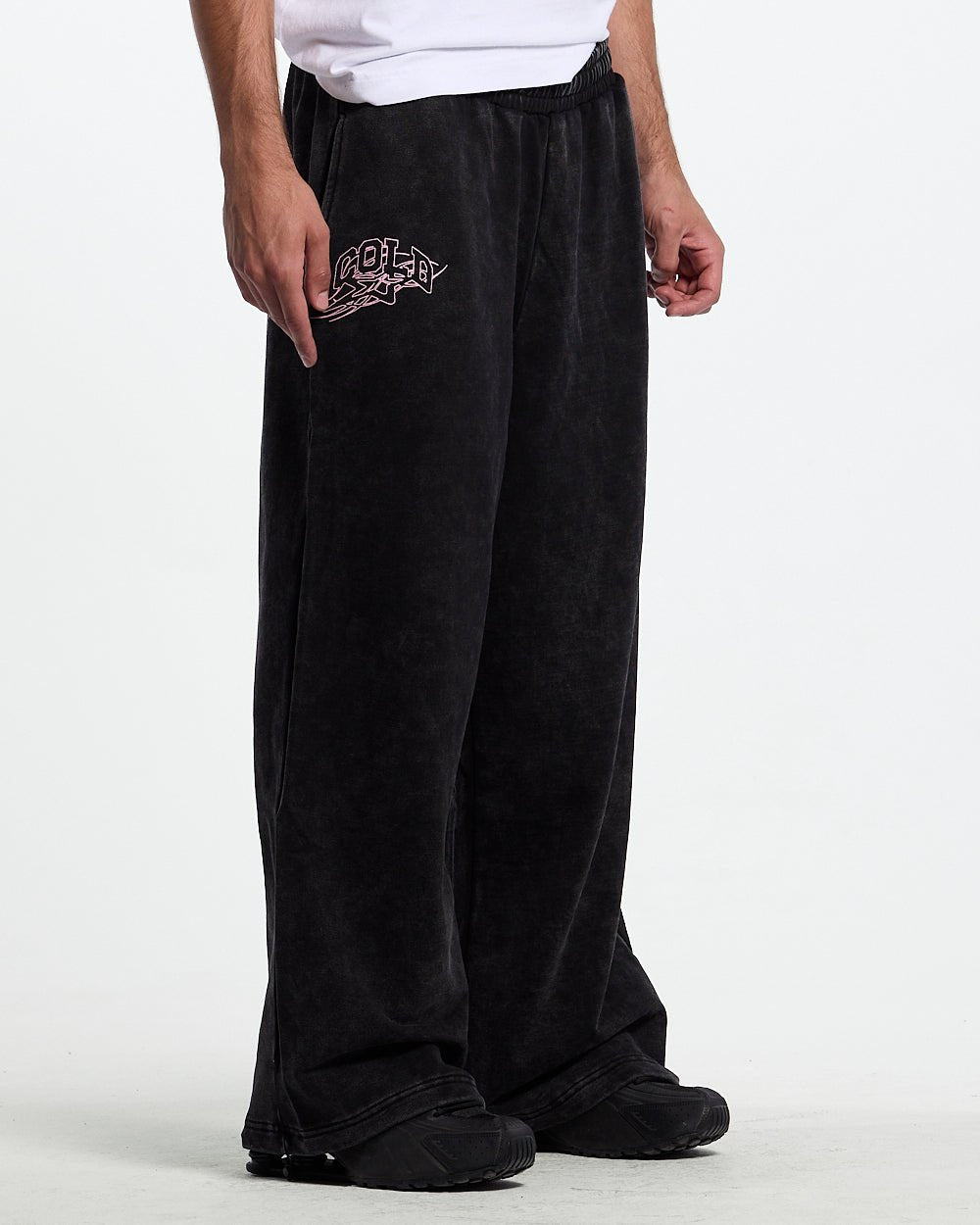 55 SWEATPANTS BLACK - washed black graphic sweatpants, front view on male model - Cold Culture