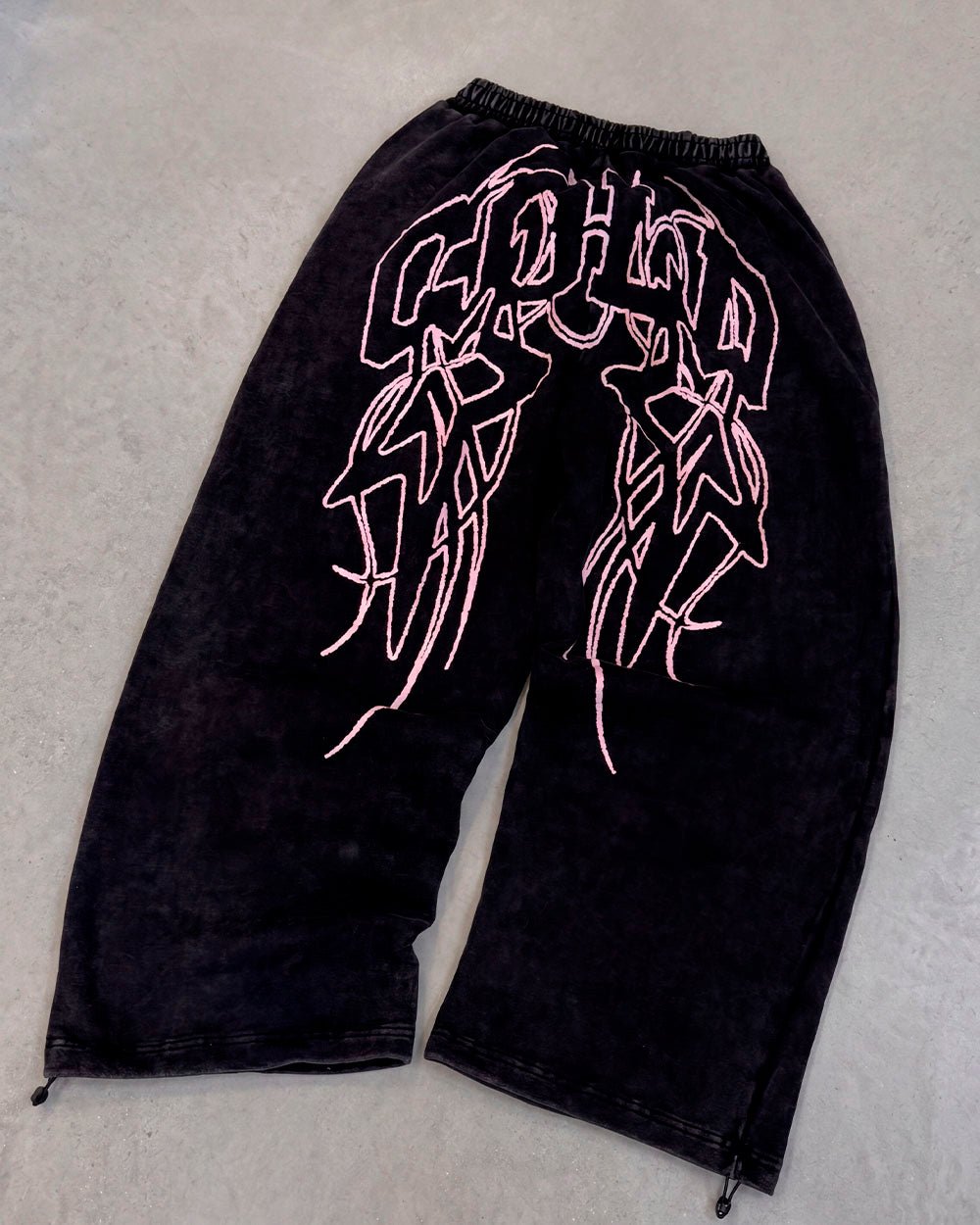 55 SWEATPANTS BLACK - washed black graphic sweatpants, flat lay - Cold Culture