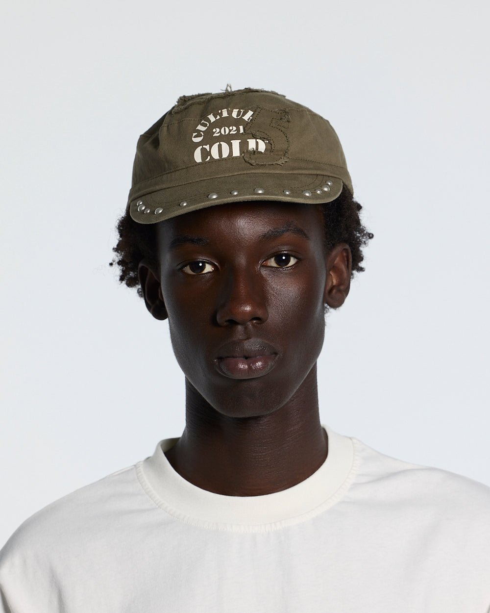 BOSSMAN CAP BROWN - brown studded cap, front view on male model - Cold Culture