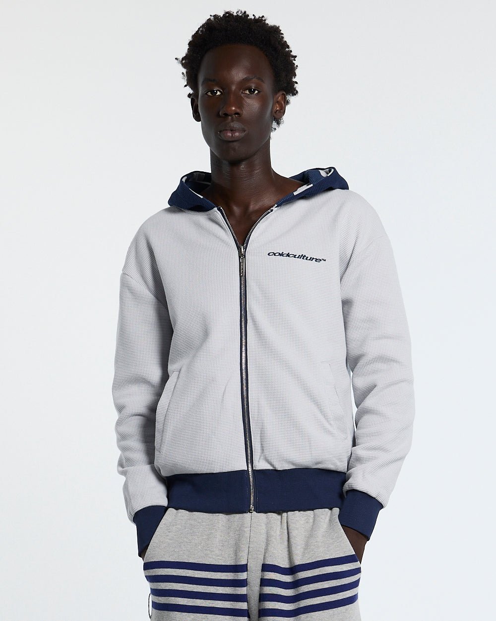 UNTRUE WAFFLE REVERSIBLE ZIP HOODIE BLUE - navy striped reversible zip-up hoodie, front view on male model - Cold Culture