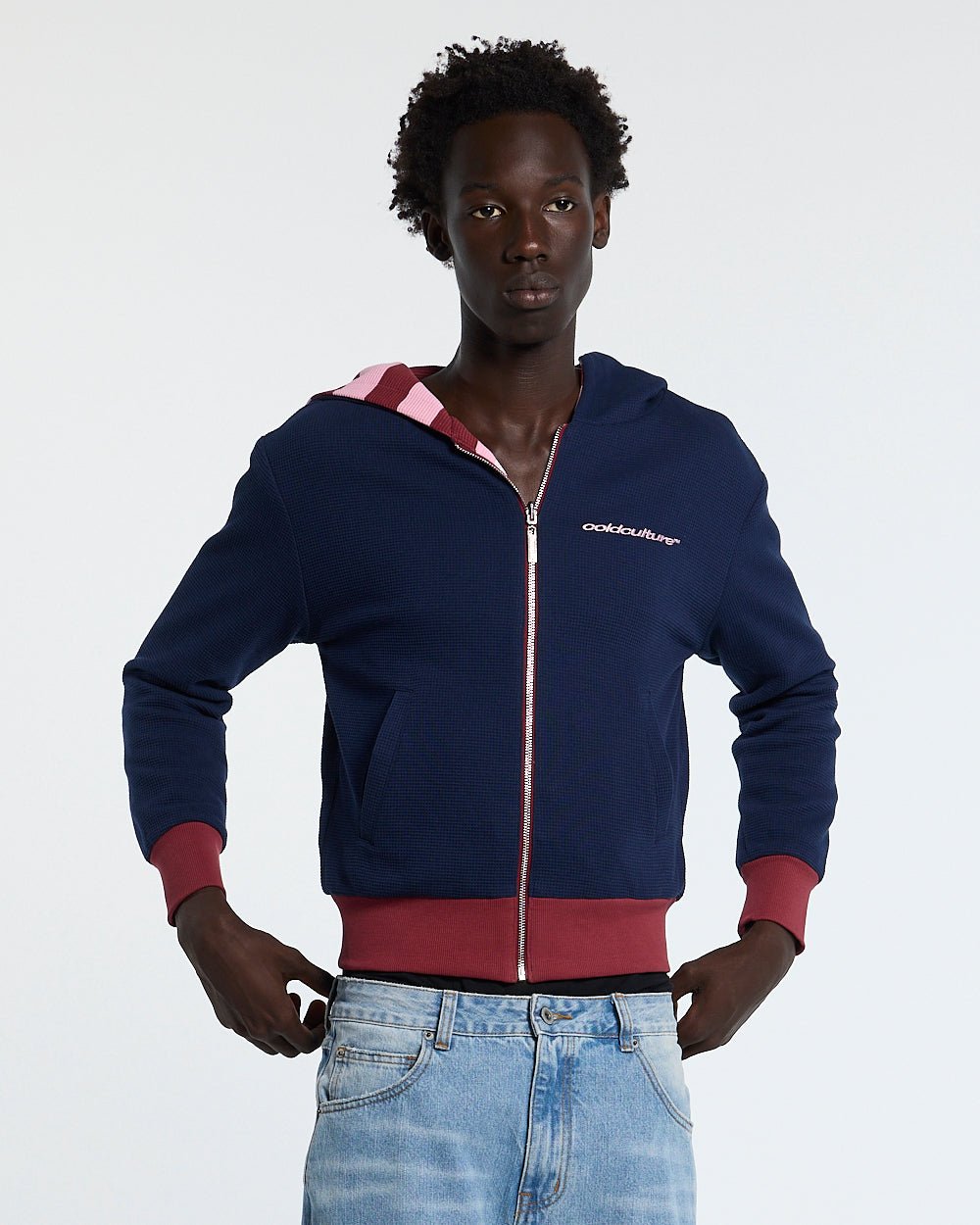 UNTRUE WAFFLE REVERSIBLE ZIP HOODIE PINK - pink striped reversible zip-up hoodie, front view on male model - Cold Culture
