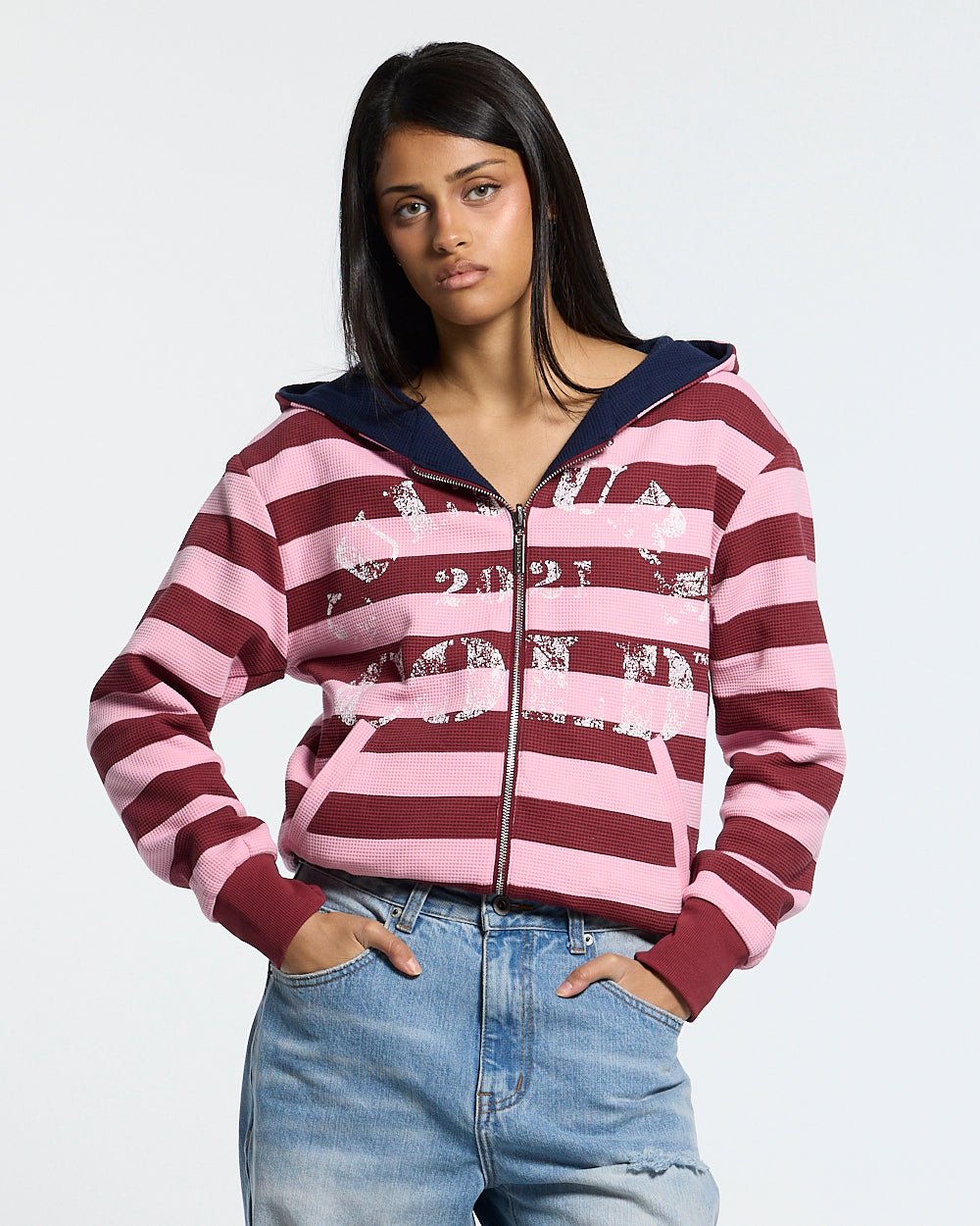 UNTRUE WAFFLE REVERSIBLE ZIP HOODIE PINK - pink striped reversible zip-up hoodie, front view on female model - Cold Culture #woman