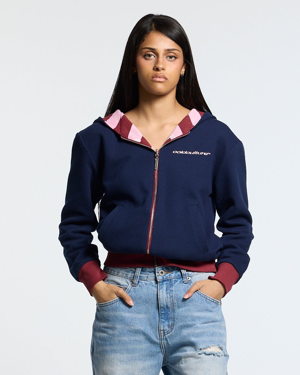UNTRUE WAFFLE REVERSIBLE ZIP HOODIE PINK - pink striped reversible zip-up hoodie, front view on female model - Cold Culture